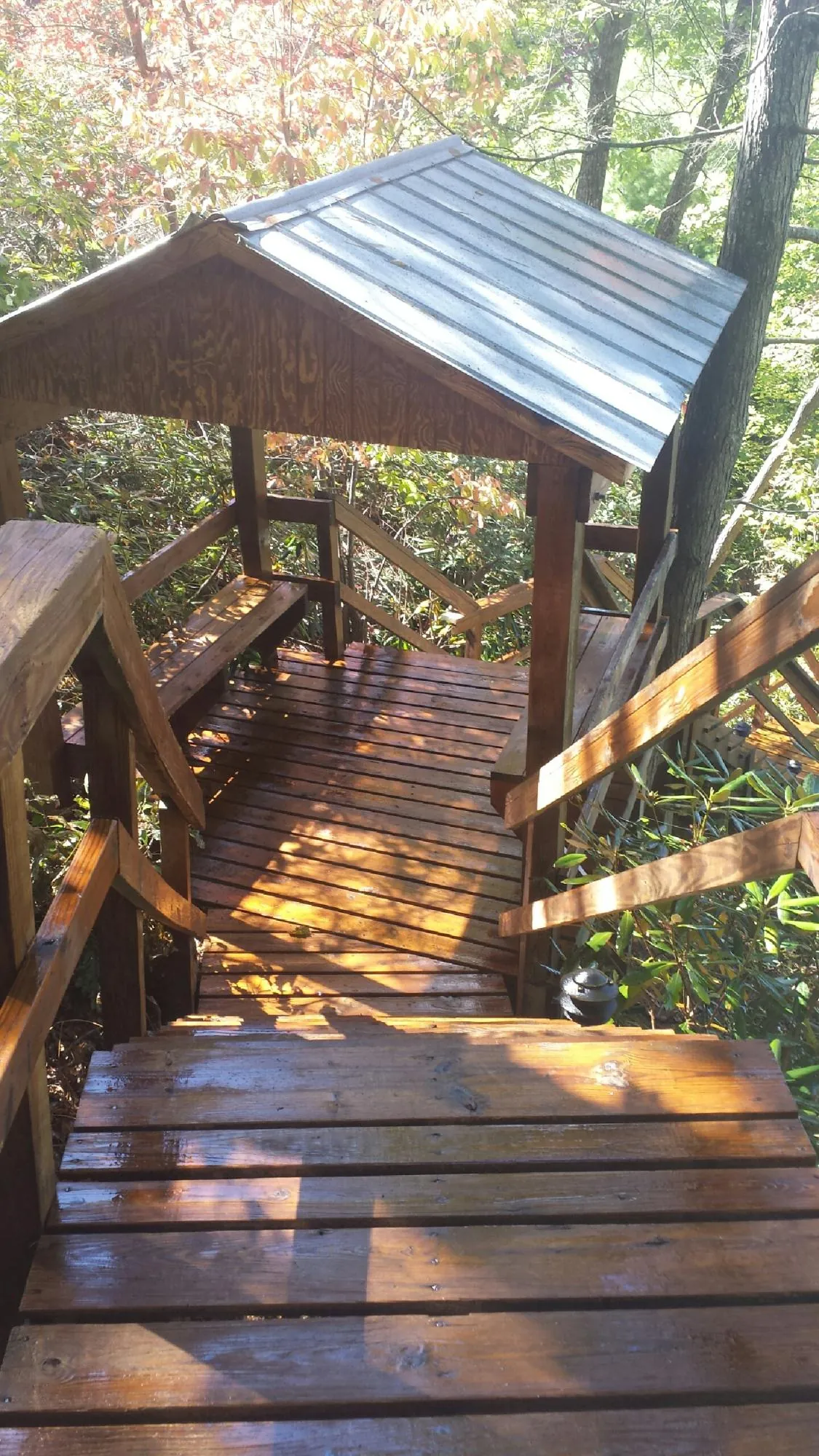 Freshly stained wood walkway and covered shelter with a metal roof in Palos Heights